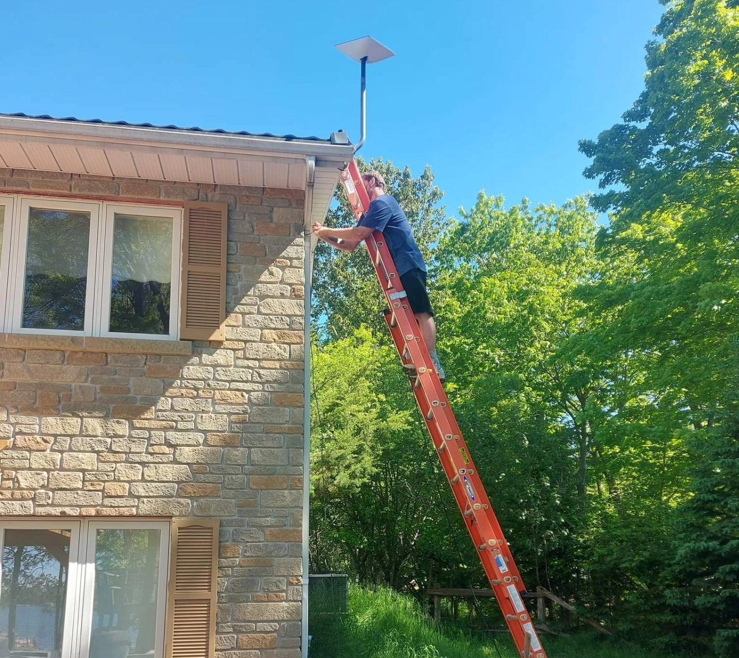 Northern Internet Solutions technician installing a Starlink dish in Northern Ontario